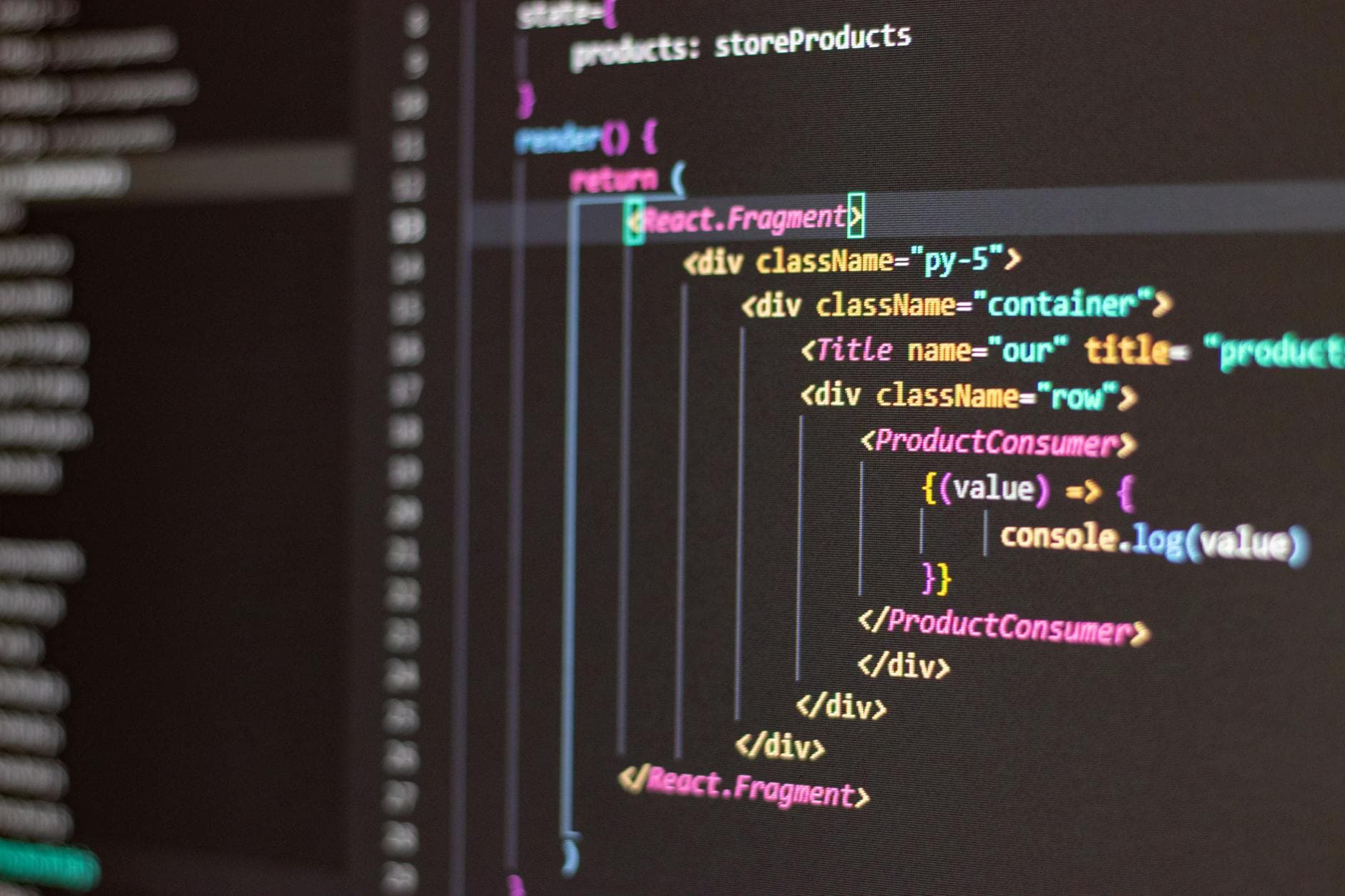 Two agency founders reviewing custom software code on a monitor in a modern UK office