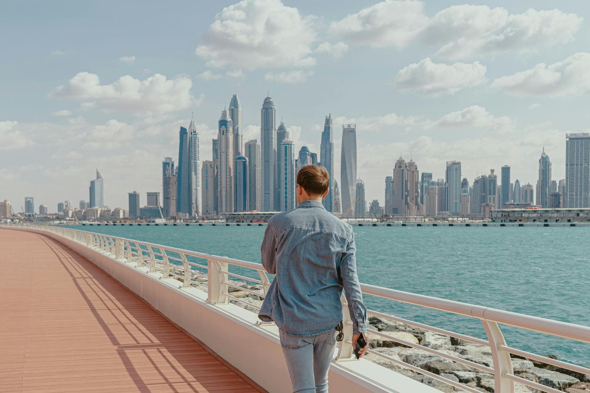 Two agency founders reviewing legal documents at a desk in a modern Dubai office with city skyline visible through window
