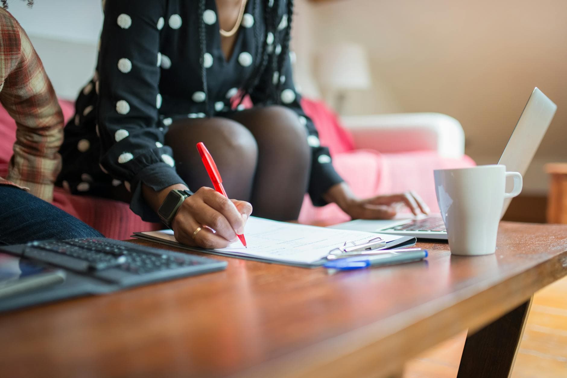 Agency founder reviewing an IR35 Status Determination Statement for a freelance designer on a laptop in a modern UK office
