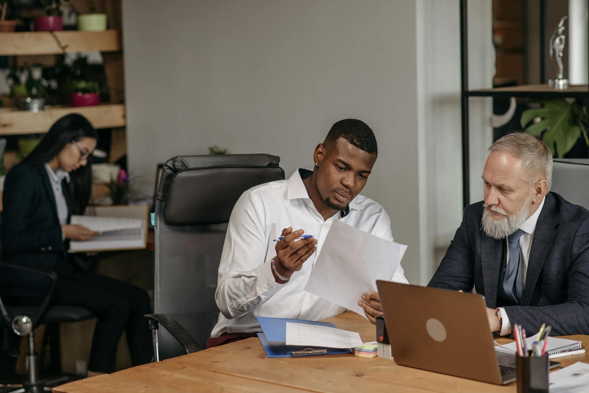 ICAEW qualified accountant reviewing P11D forms with an agency director in a modern London office