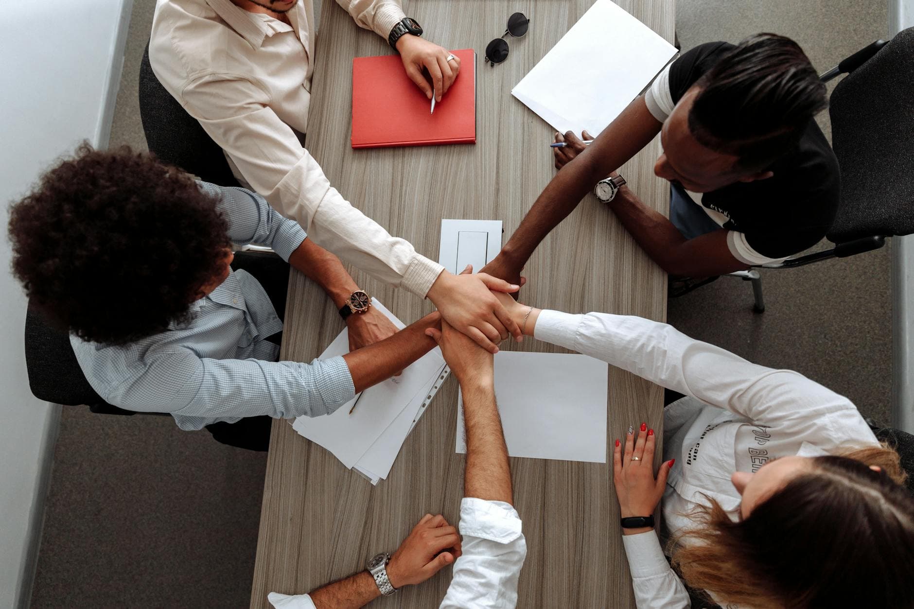 Two agency founders reviewing group structure documents with their ICAEW accountant in a modern UK office