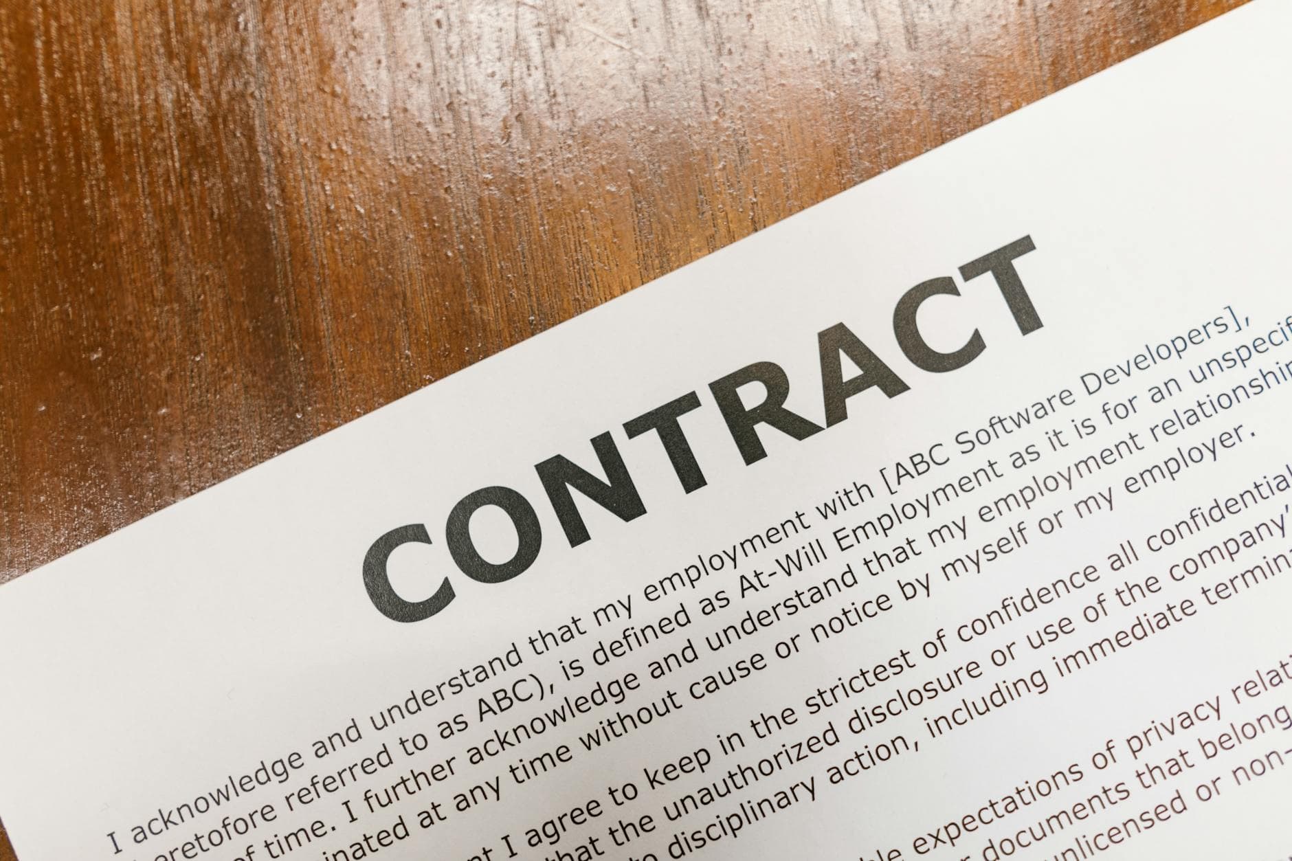 Agency founder reviewing a sale agreement and retainer contract list with an accountant in a Manchester office