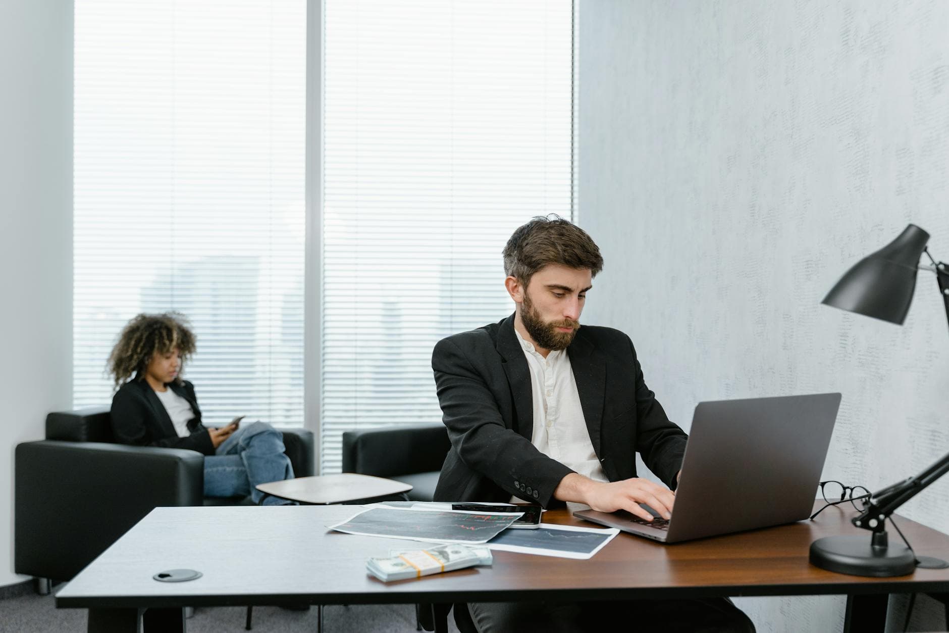 ICAEW qualified accountant reviewing paperwork with a UK agency founder in a modern office setting