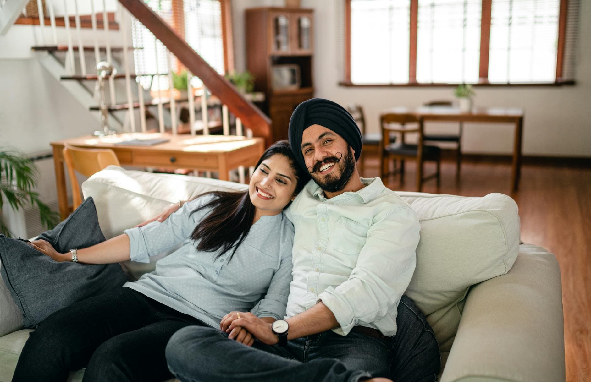 Agency founder and spouse reviewing financial documents together at a modern office desk