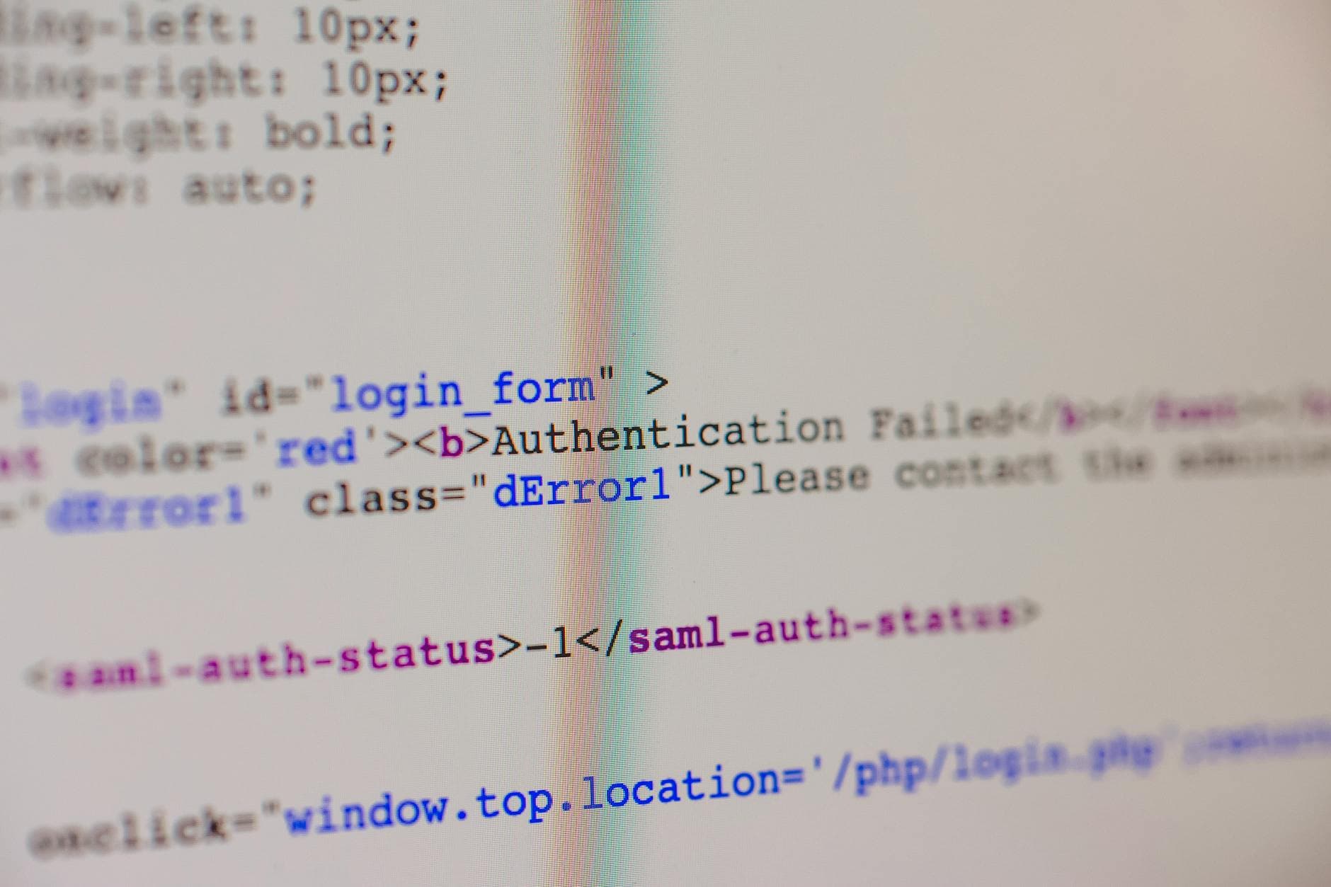 UK agency founder reviewing a status determination statement for a web developer contract on a laptop in a modern office