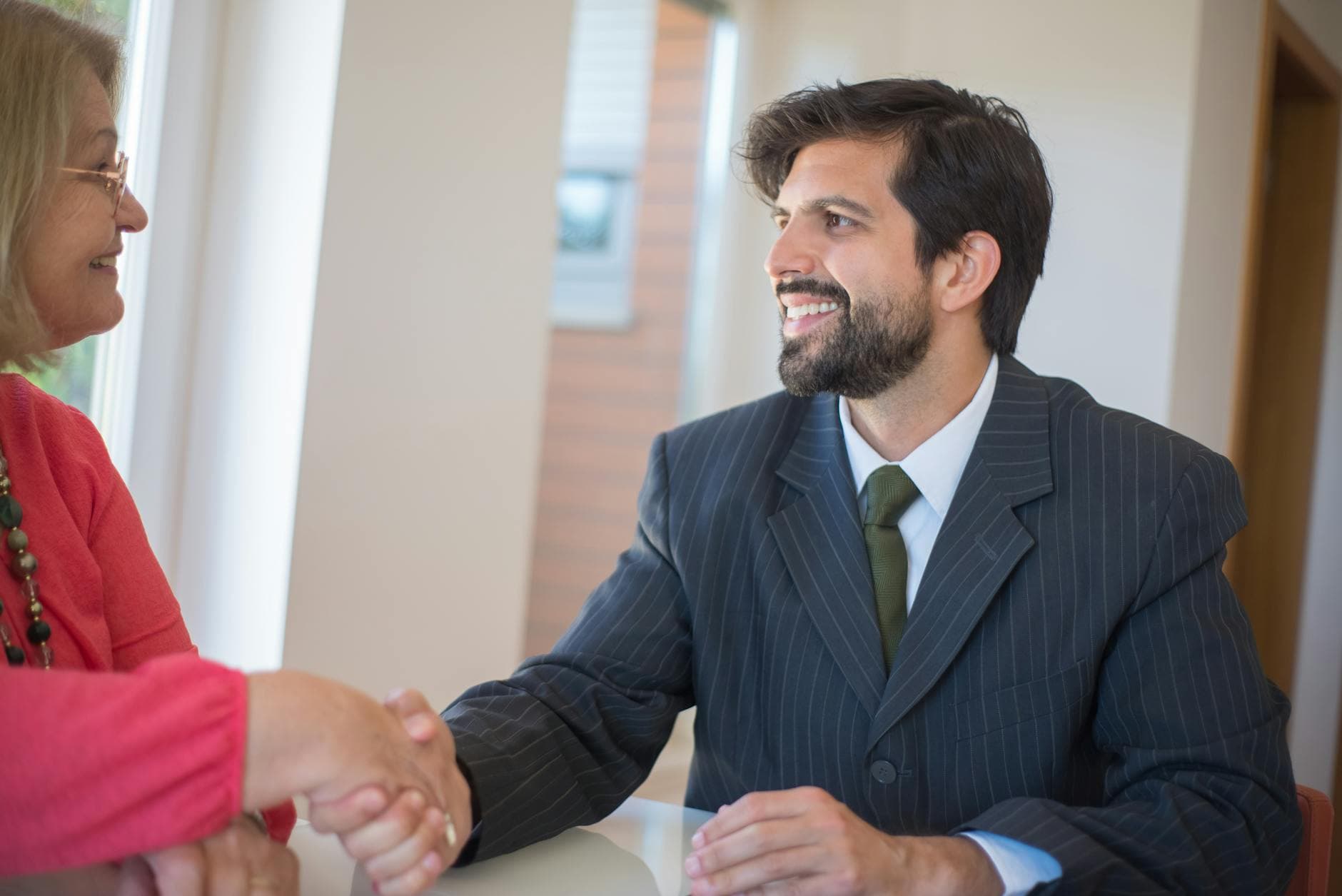 UK agency founder reviewing client contracts with a solicitor in a London meeting room before relocating to Dubai