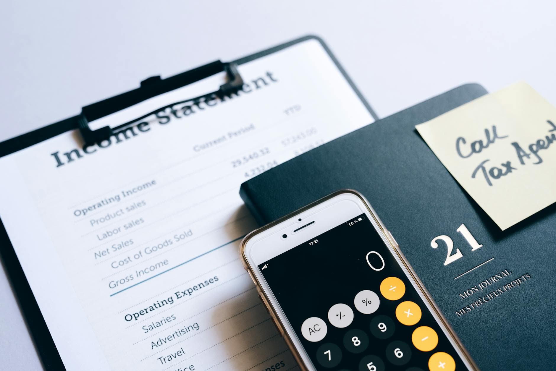 Two agency founders reviewing financial reports with their ICAEW qualified accountant in a modern UK office